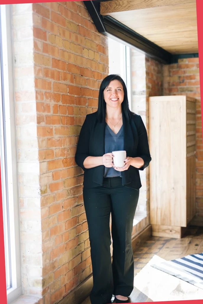 Editor standing near a restored brick mill with canal